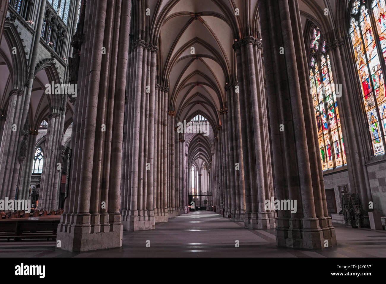 Cologne gothic cathedral interior, Germany, Europe. Famous monument and most visited place, symbol of Cologne. Inside Cologne Dom, nave, columns, stai Stock Photo