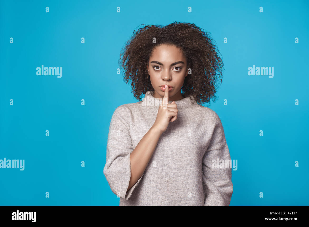 Young african woman studio portrait isolated on blue Stock Photo