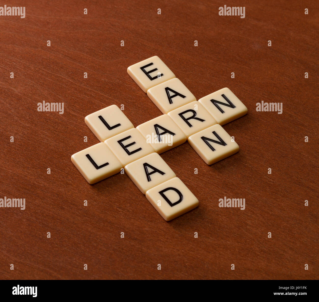 Crossword puzzle with words Learn, Lead and Earn. Leadership concept