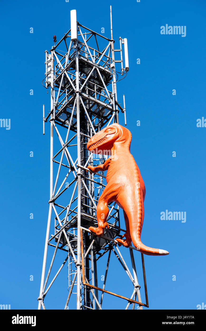 Orange plastic dinosaur on an antenna tower Stock Photo Alamy