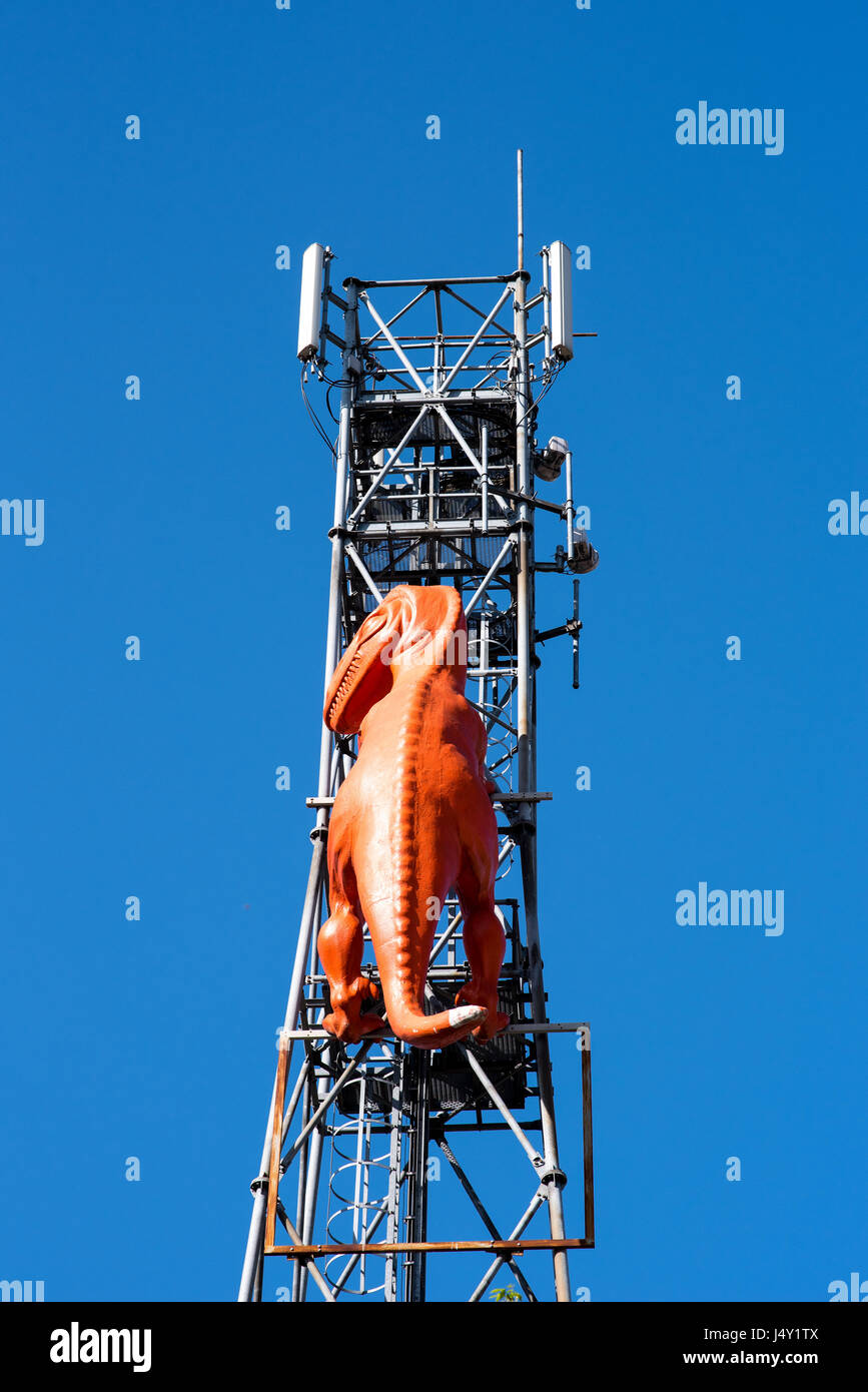 Orange plastic dinosaur on an antenna tower Stock Photo Alamy