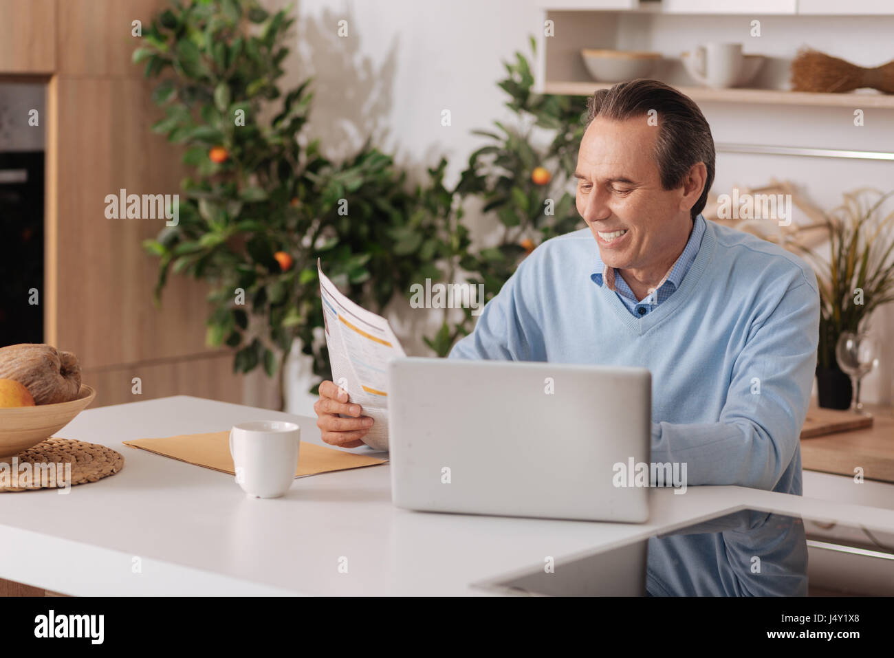 Cheerful aged man enjoying morning at home Stock Photo