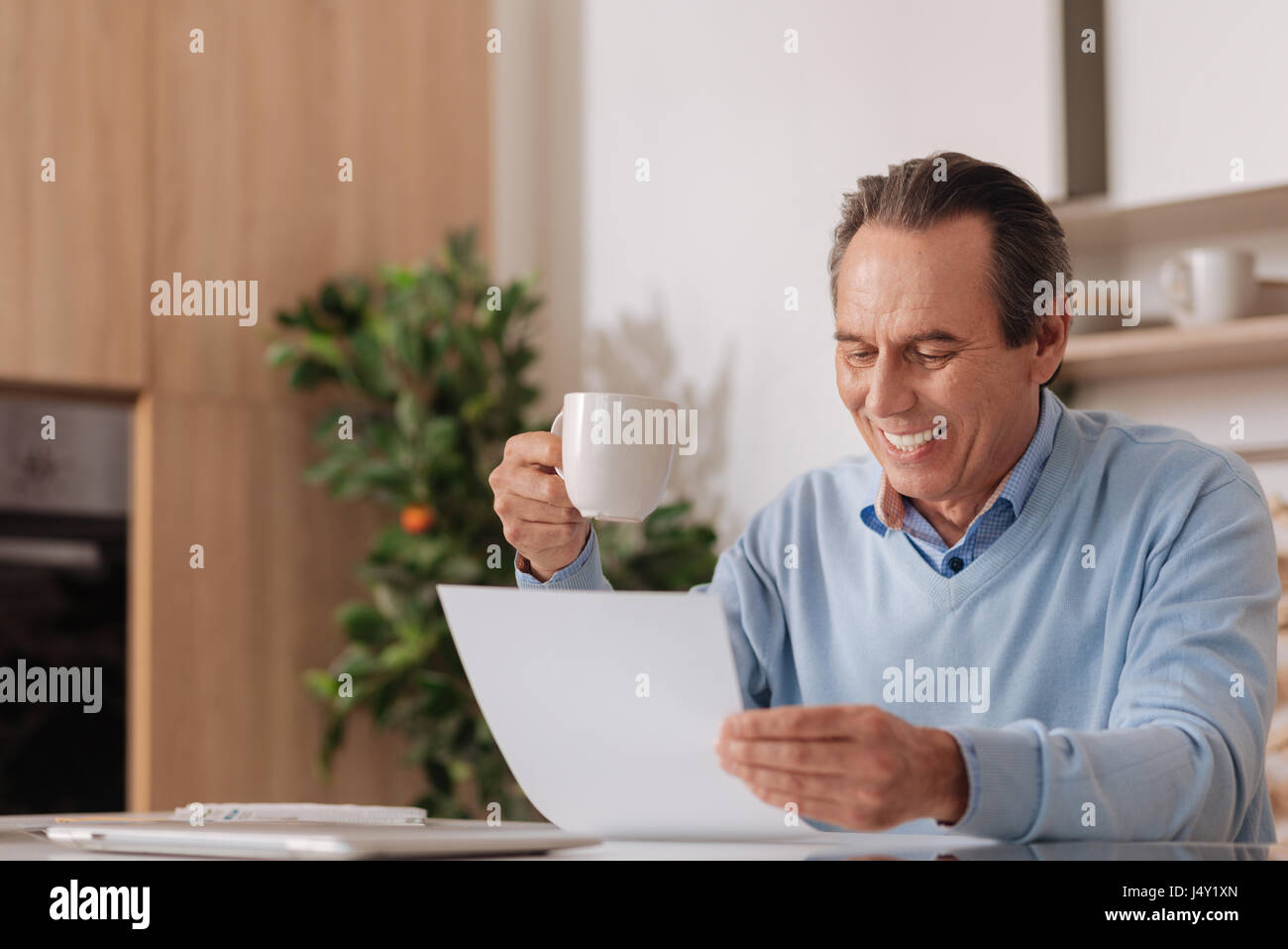 Aging delightful freelancer working at home Stock Photo