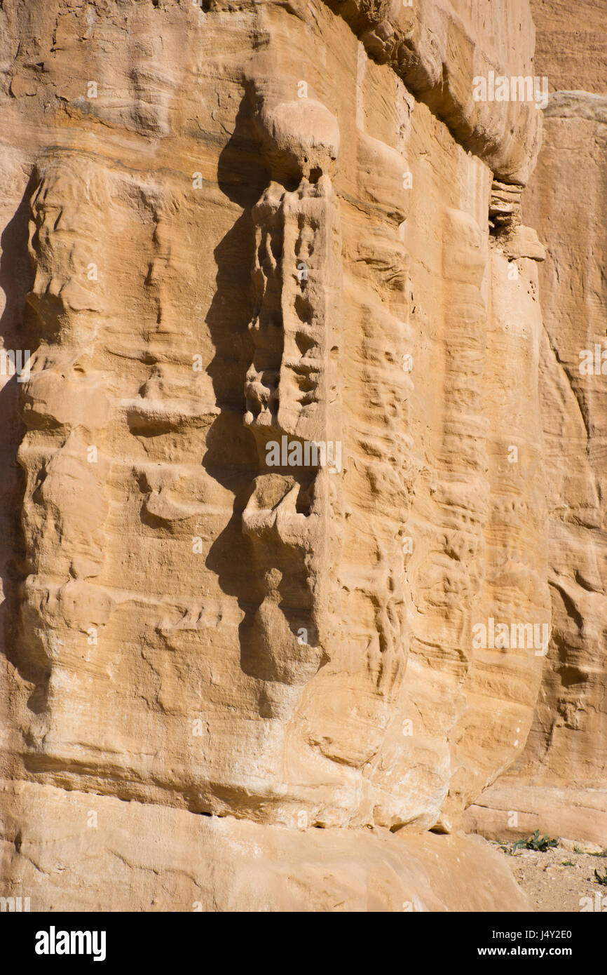 Close up of carving on stone Djinn Block marking the entrance of a tomb in Petra Jordan, the ancient Nabataean city of Raqmu. Stock Photo