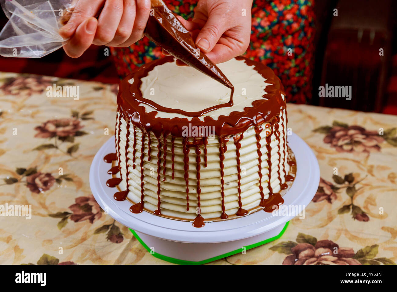 covering a cake with chocolate icing sponge cake covered in chocolate