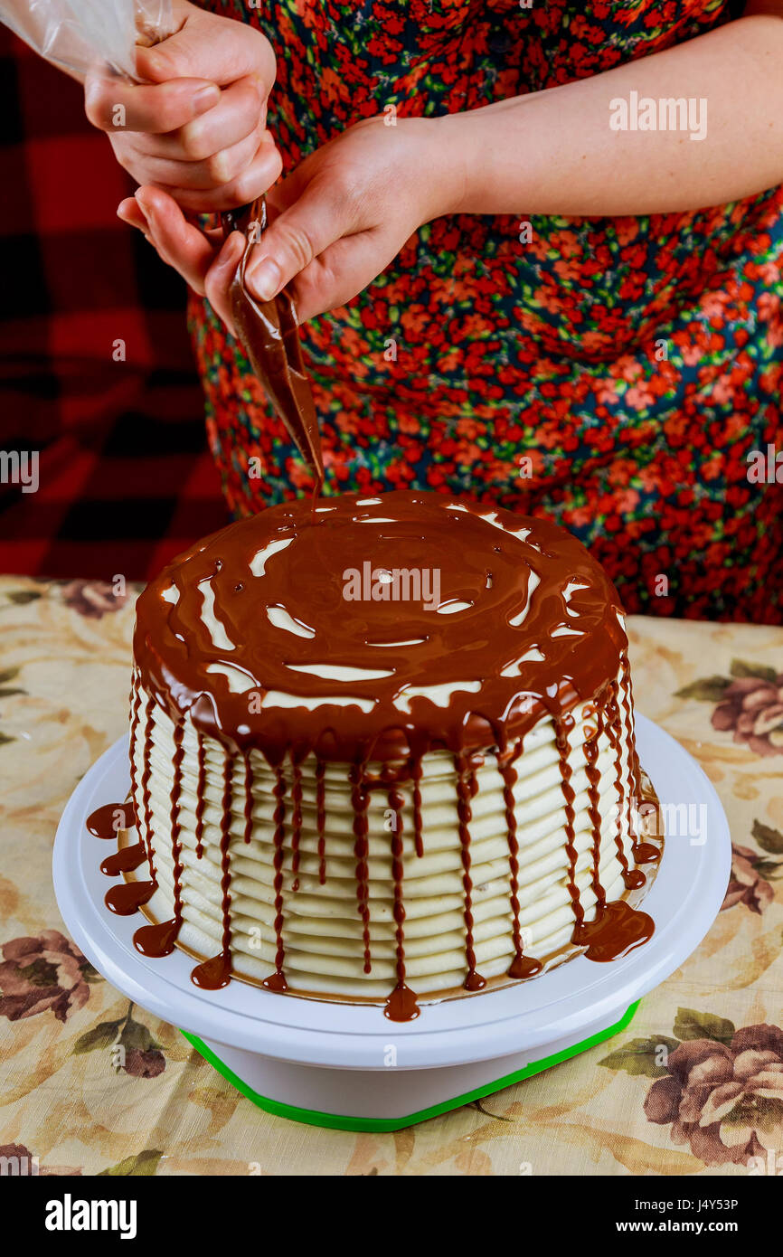 covering a cake with chocolate icing sponge cake covered in chocolate