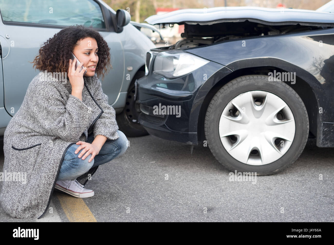 Woman calling emergency help after a car crash Stock Photo