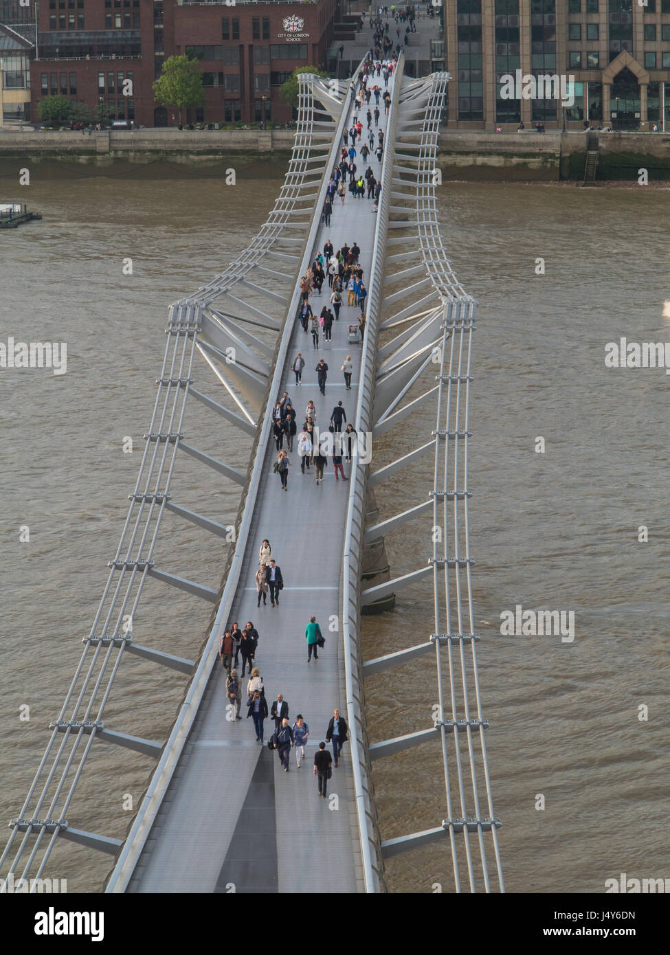 St Paul's cathedral and blurred people crossing the Millennium Bridge Stock Photo