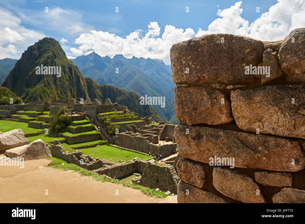 Stone brick wall in blurred background of Machu Picchu. Selected focus on stone wall in Machu Picchu Stock Photo