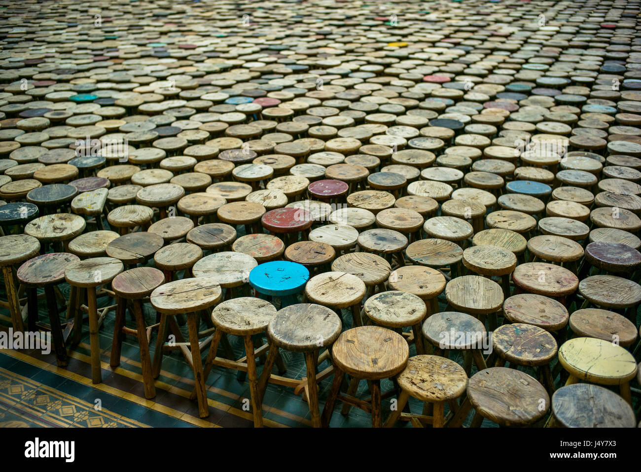 Ming period three legged stools, part of the Chinese artist AiWeiwei installation in the Martin Gropius museum, Berlin. Stock Photo