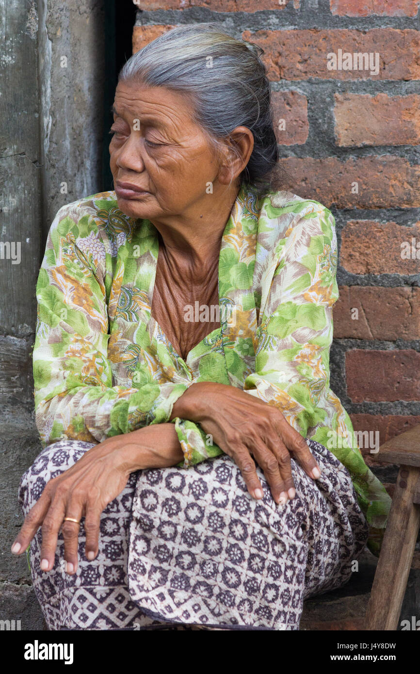 Old woman sat on the street in Denpasar, Bali, Indonesia Stock Photo - Alamy