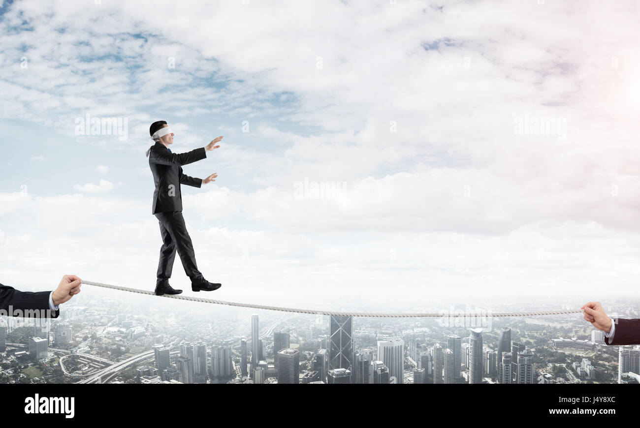 Business concept of risk support and assistance with man balancing on ...