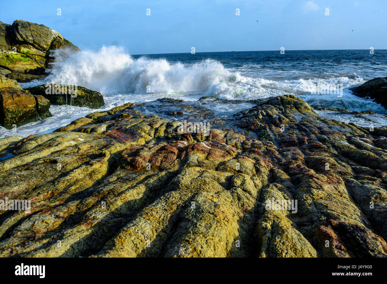 waves washing over  Rocks Kerala Indian ocean Stock Photo
