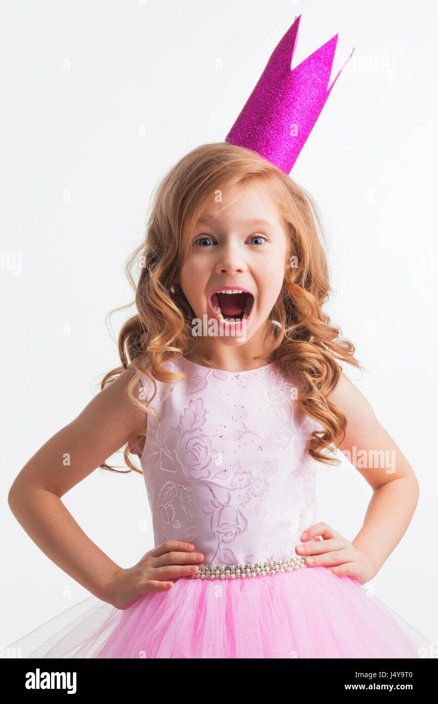 Little princess girl in pink crown and beautiful dress on white ...