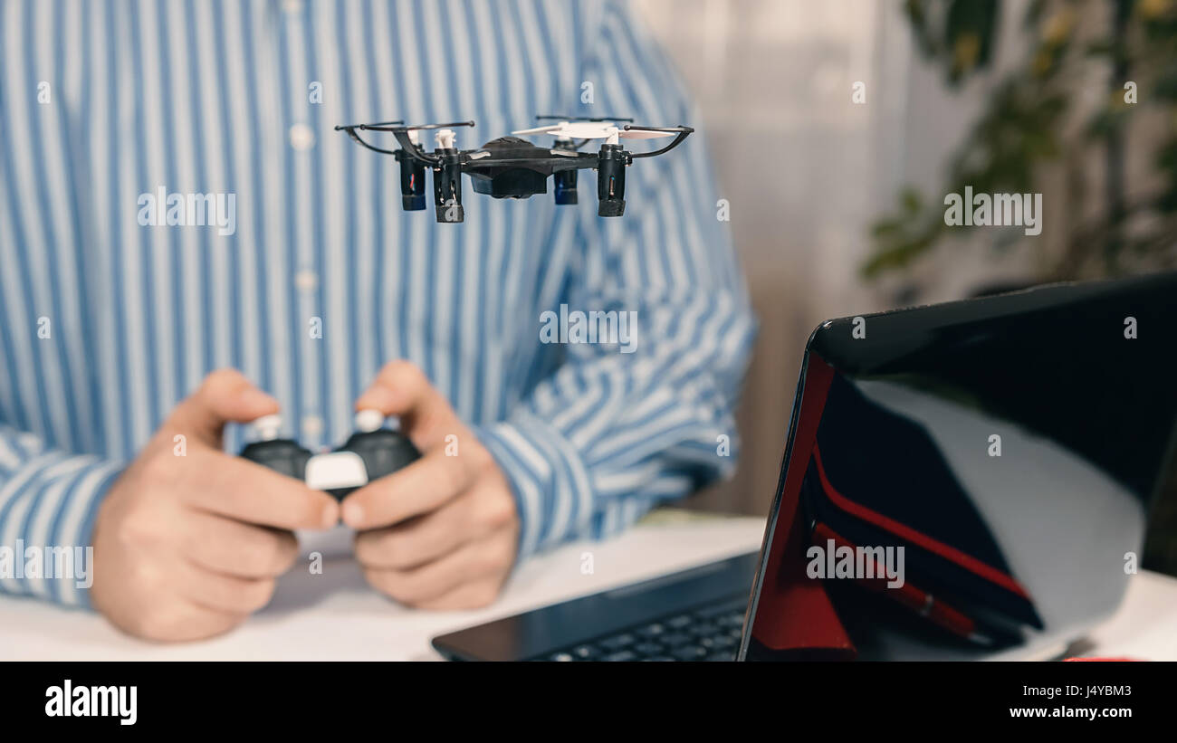 Businessman Playing With Drone Toy To Relieve Stress At Work Stock
