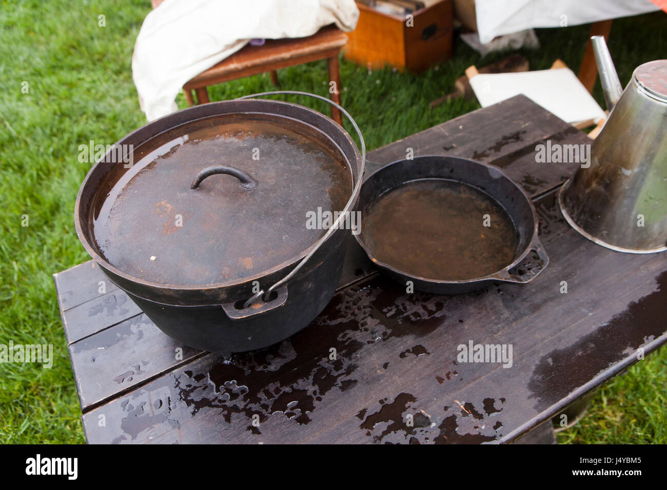 Cast iron pot and skillet on table, outdoors - USA Stock Photo