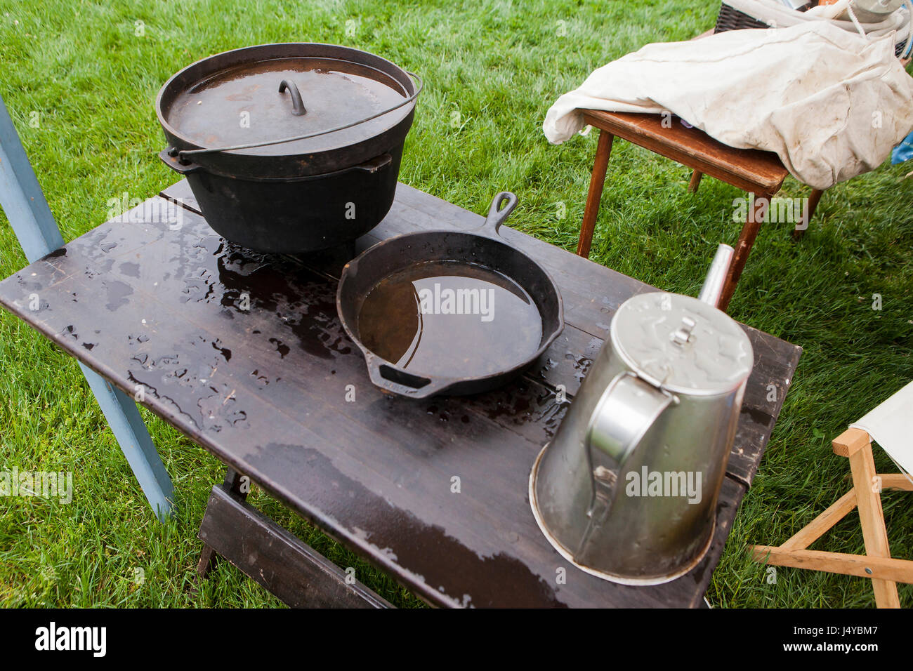 Cast iron pot and skillet on table, outdoors - USA Stock Photo