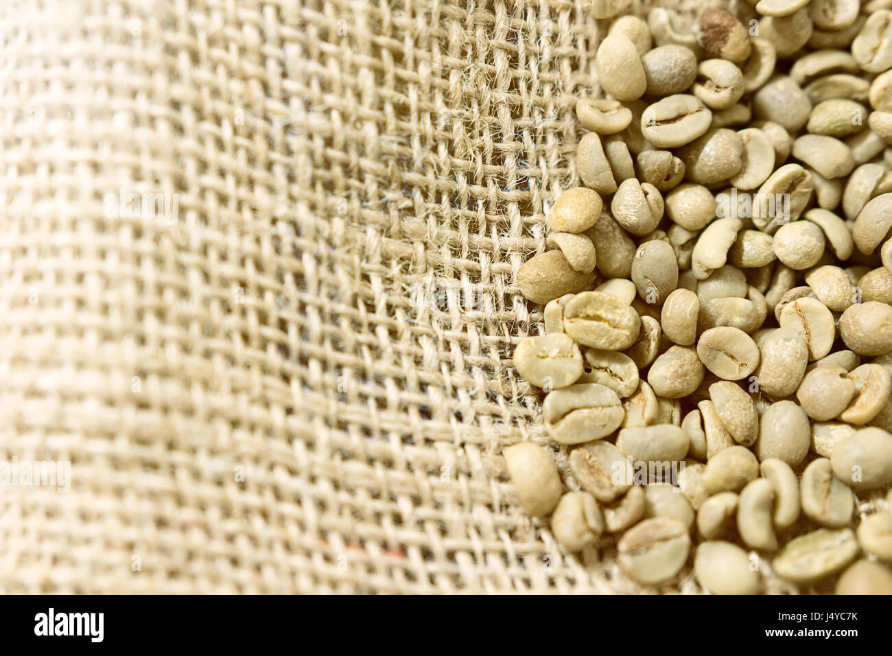 Green unroasted Coffee Beans in a sack Stock Photo - Alamy