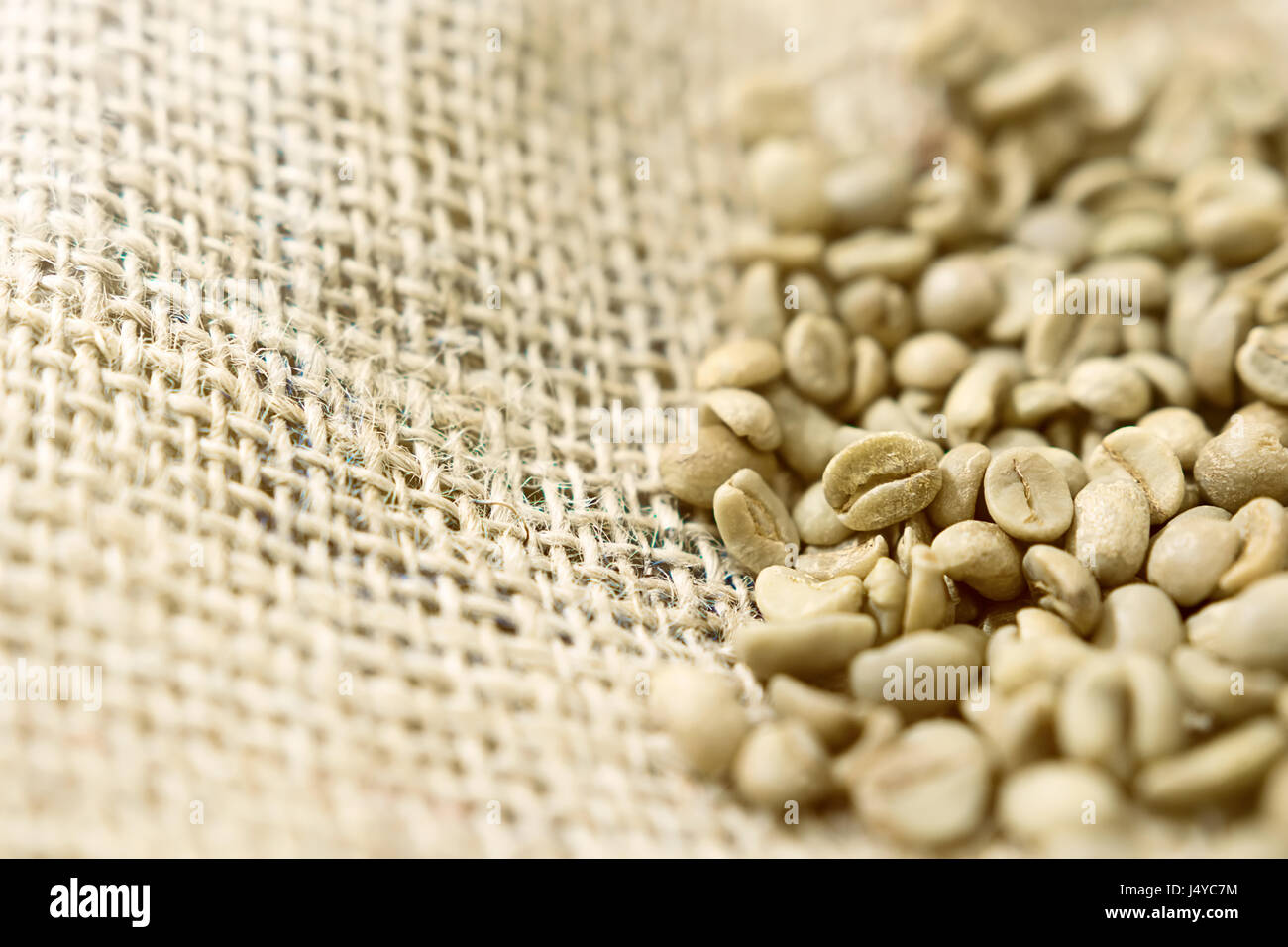Green unroasted Coffee Beans in a sack Stock Photo - Alamy