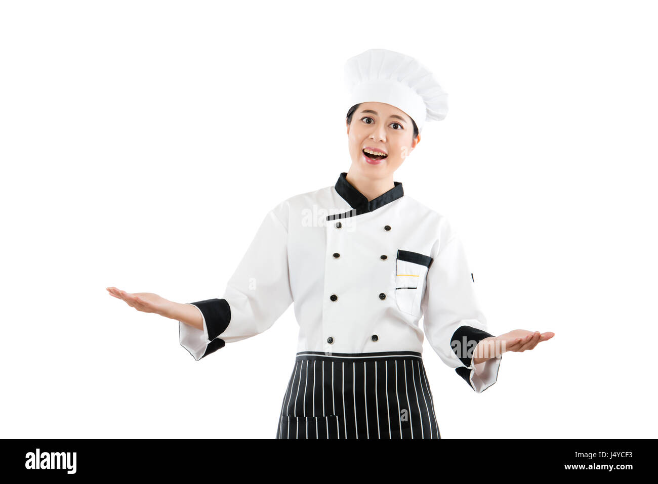 happy smile woman chef or cook presenting showing her big Feast in front of camera with open hand gesture. isolated on white background. profession an Stock Photo