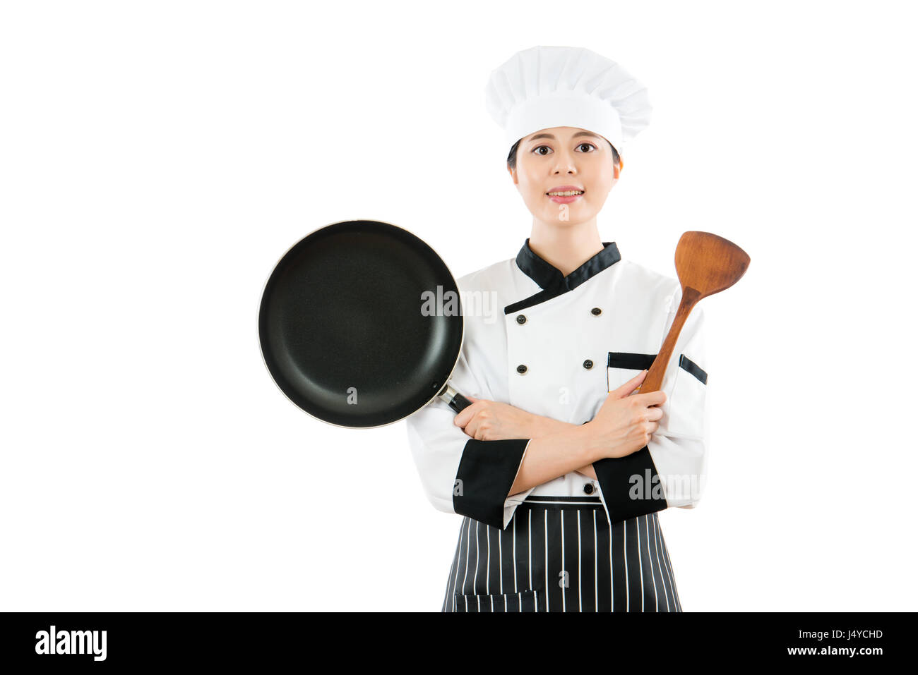 professional chef showing high level pan and easy use wooden spatula standing in blank white wall studio shooting copyspace image as advertising image Stock Photo