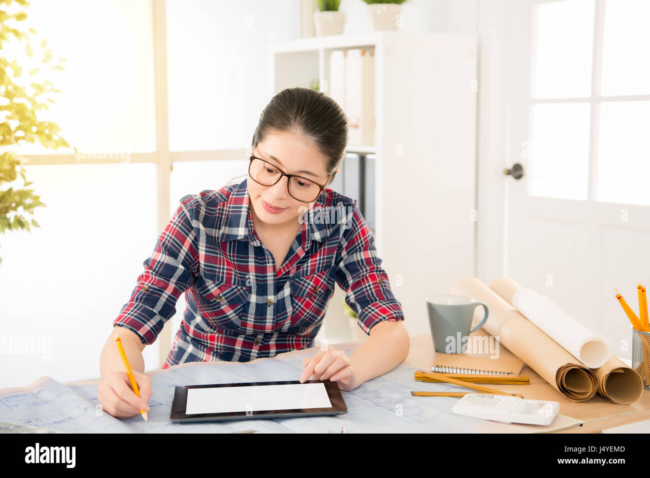 Chinese Asian Female Interior Designer Sketch By Pencil And Tablet While At The Desk In Creative Office Studio Profession And Job Occupation Concept Stock Photo Alamy