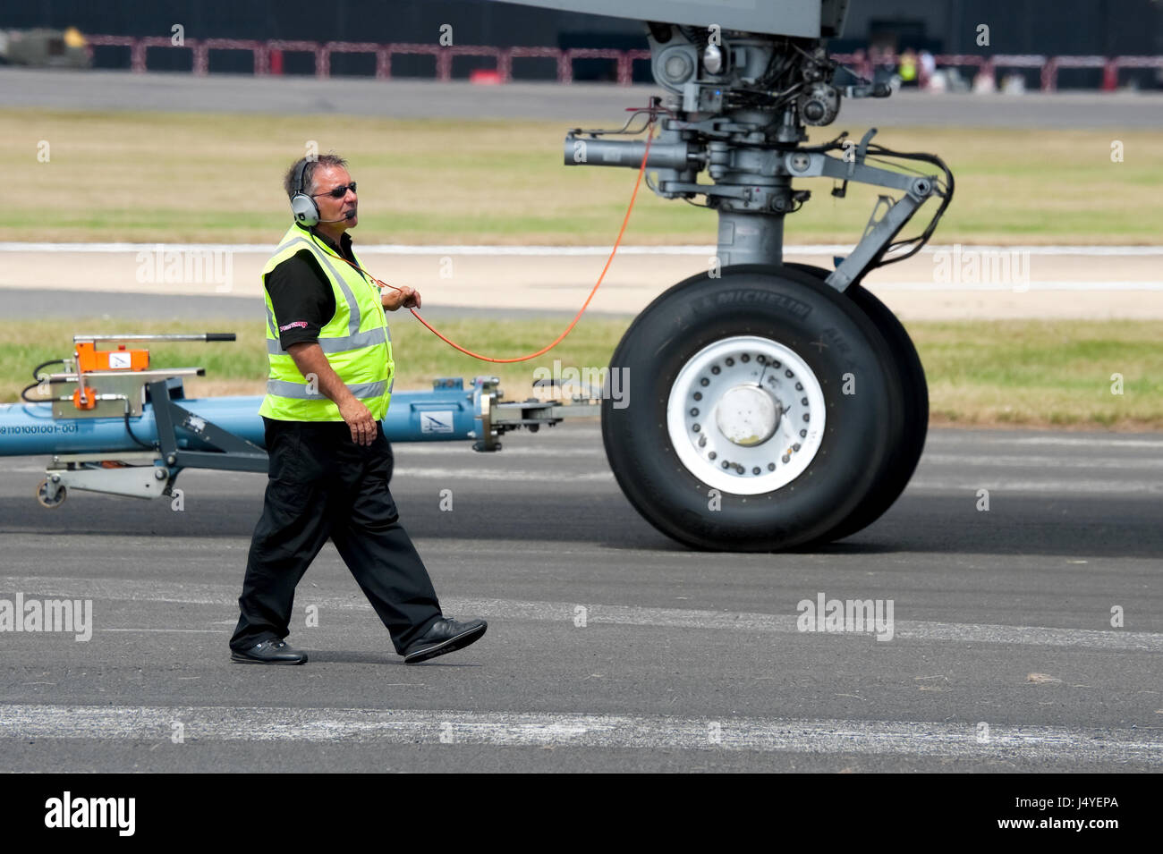 Ground crew engineer with the responsibility of leading an Airbus A380 aircraft into its display position on July 25, 2010 at Farnborough Airshow, UK Stock Photo