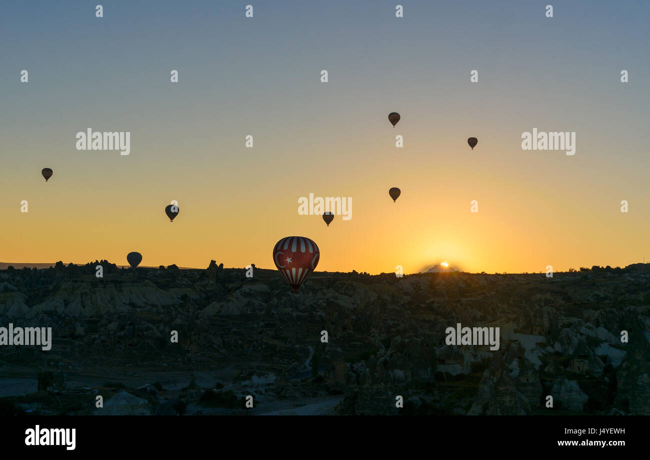 Hot air balloons flying over valley of Cappadocia at sunrise. Nevsehir ...