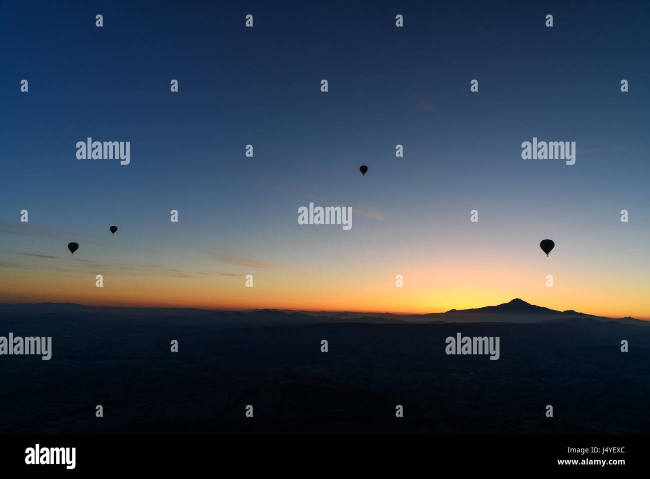 Hot air balloons flying over valley of Cappadocia at sunrise. Nevsehir ...