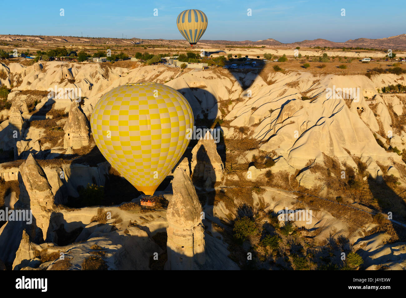 Hot air balloons flying over valley of Cappadocia in the morning ...