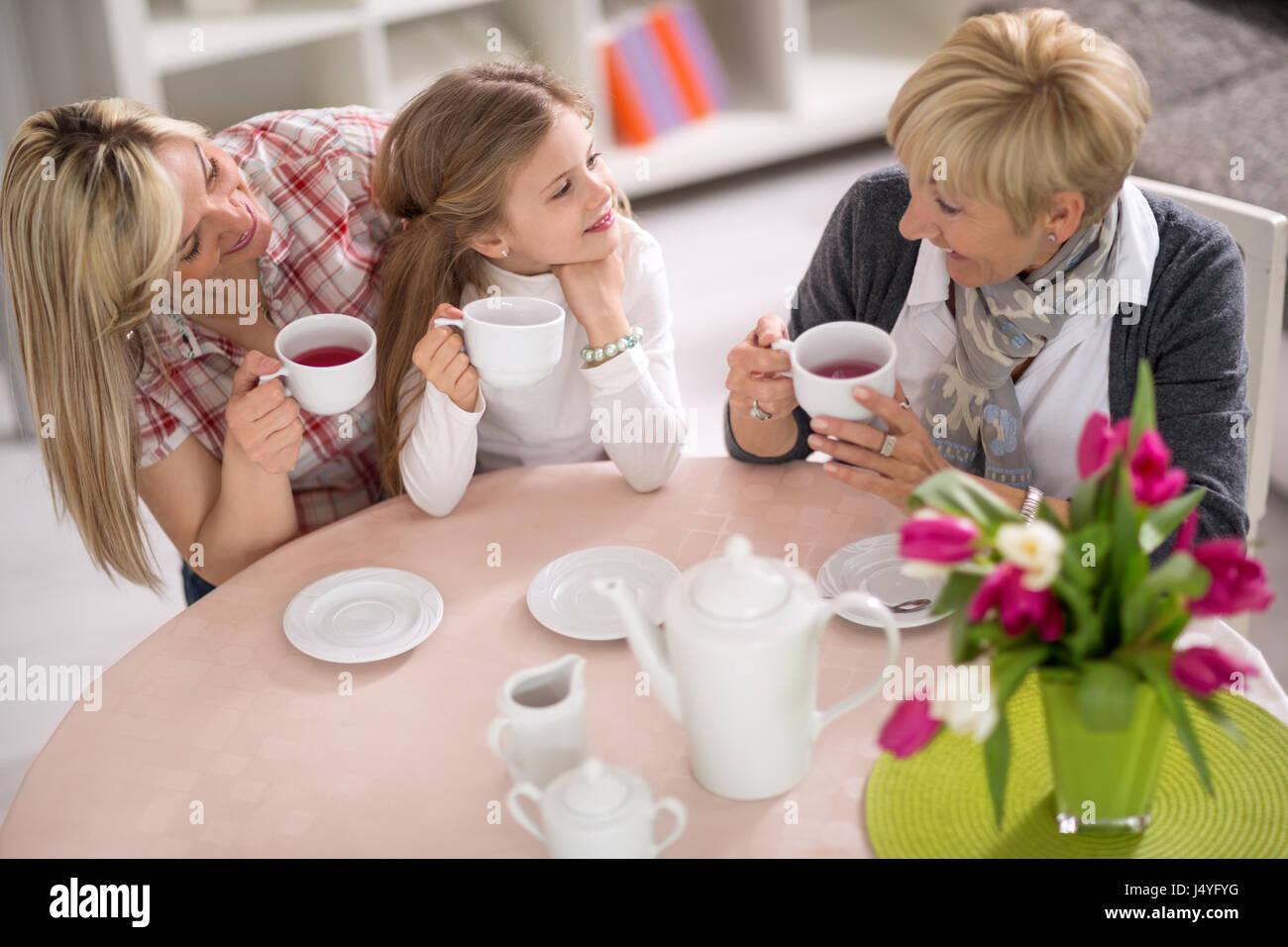 Three female generations of one family at home. Mother, grandmother and daughter together on tea party Stock Photo