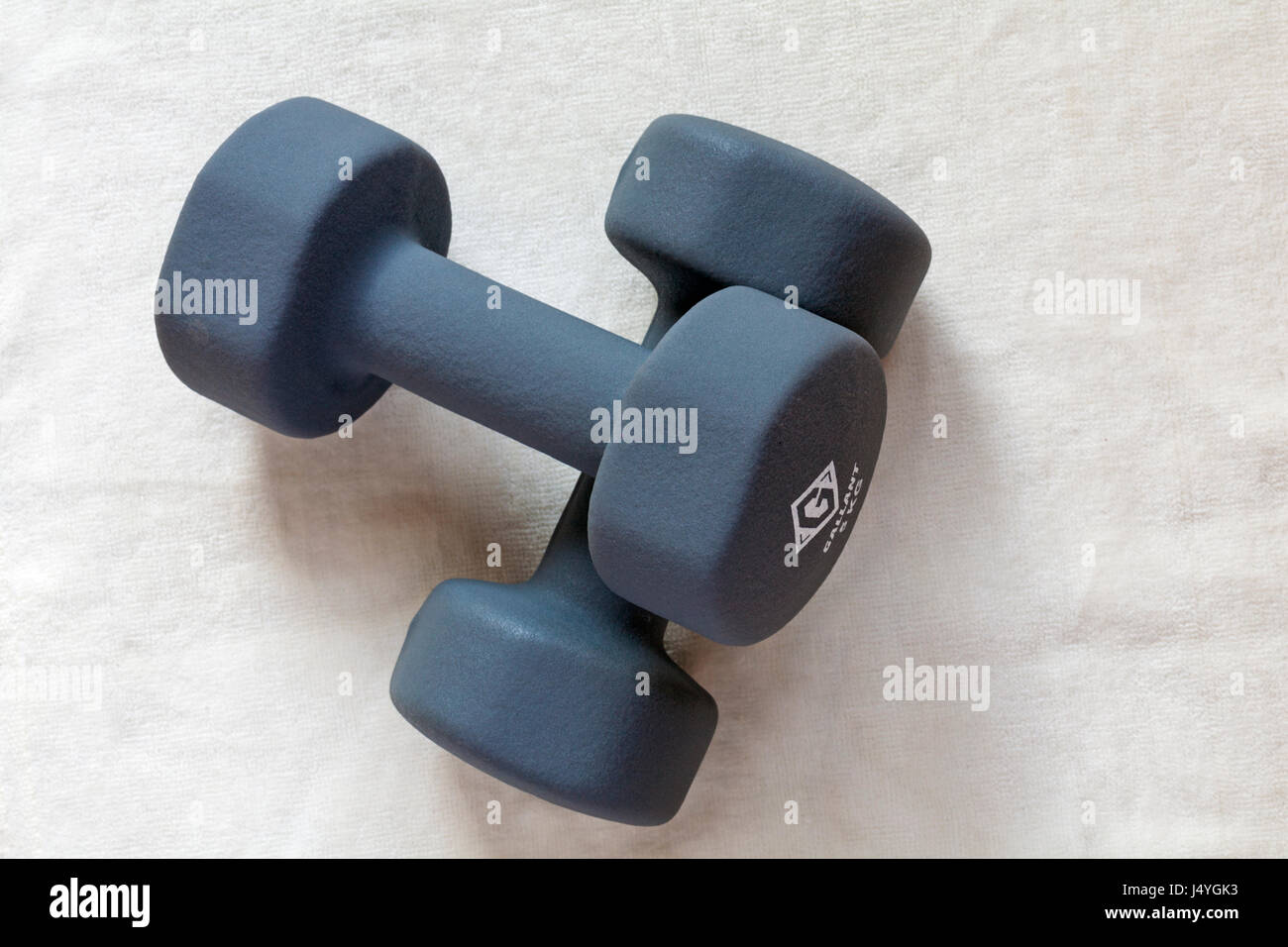 Pair of grey Gallant Hand Weights each weighing 5kg x 2 = 10kg resting on cream towel Stock Photo