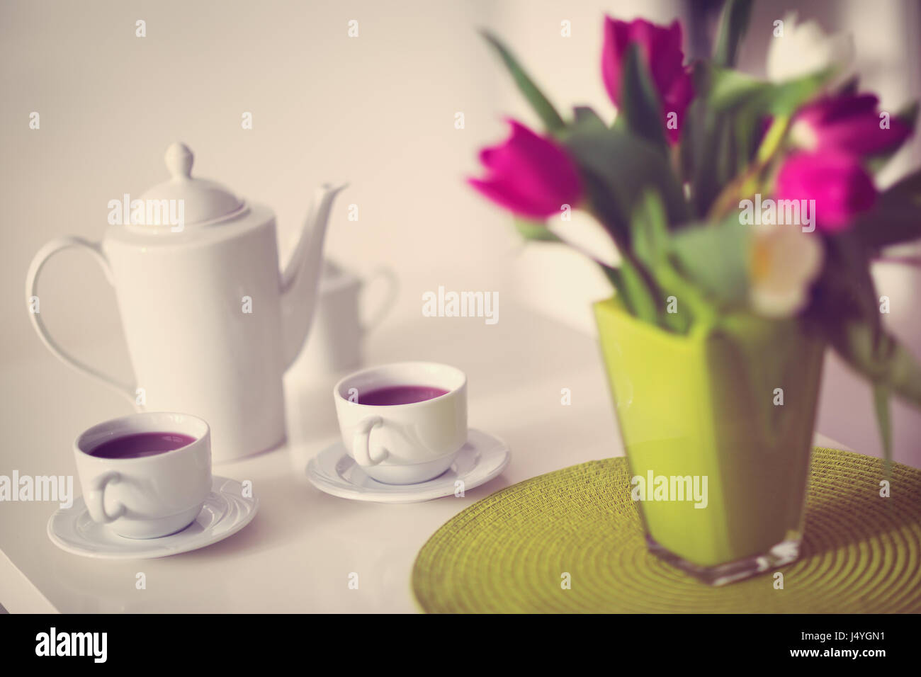 cups of tea with a teapot on decorated table Stock Photo