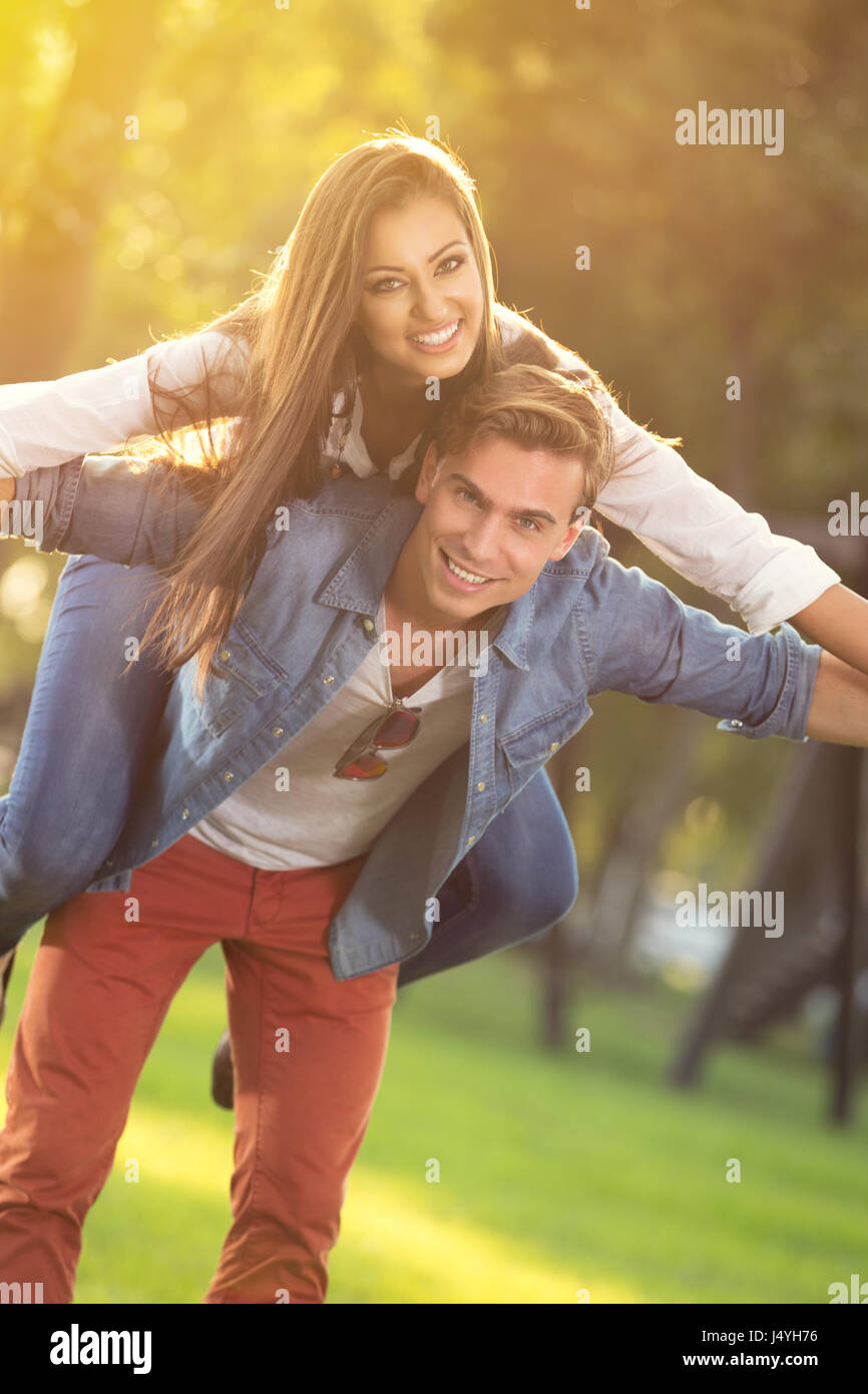 happy young couple having fun in sunny forest Stock Photo - Alamy