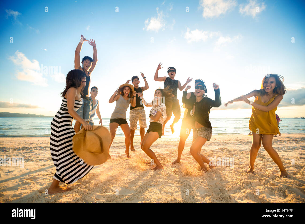 Happy young people on beach Stock Photo - Alamy