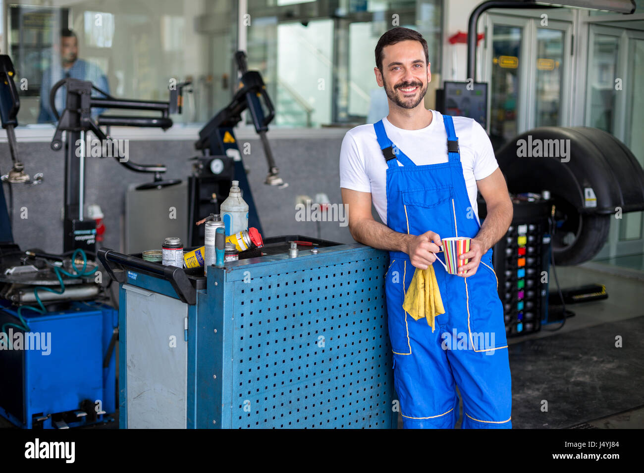 Satisfied male engineer in an auto repair shop Stock Photo