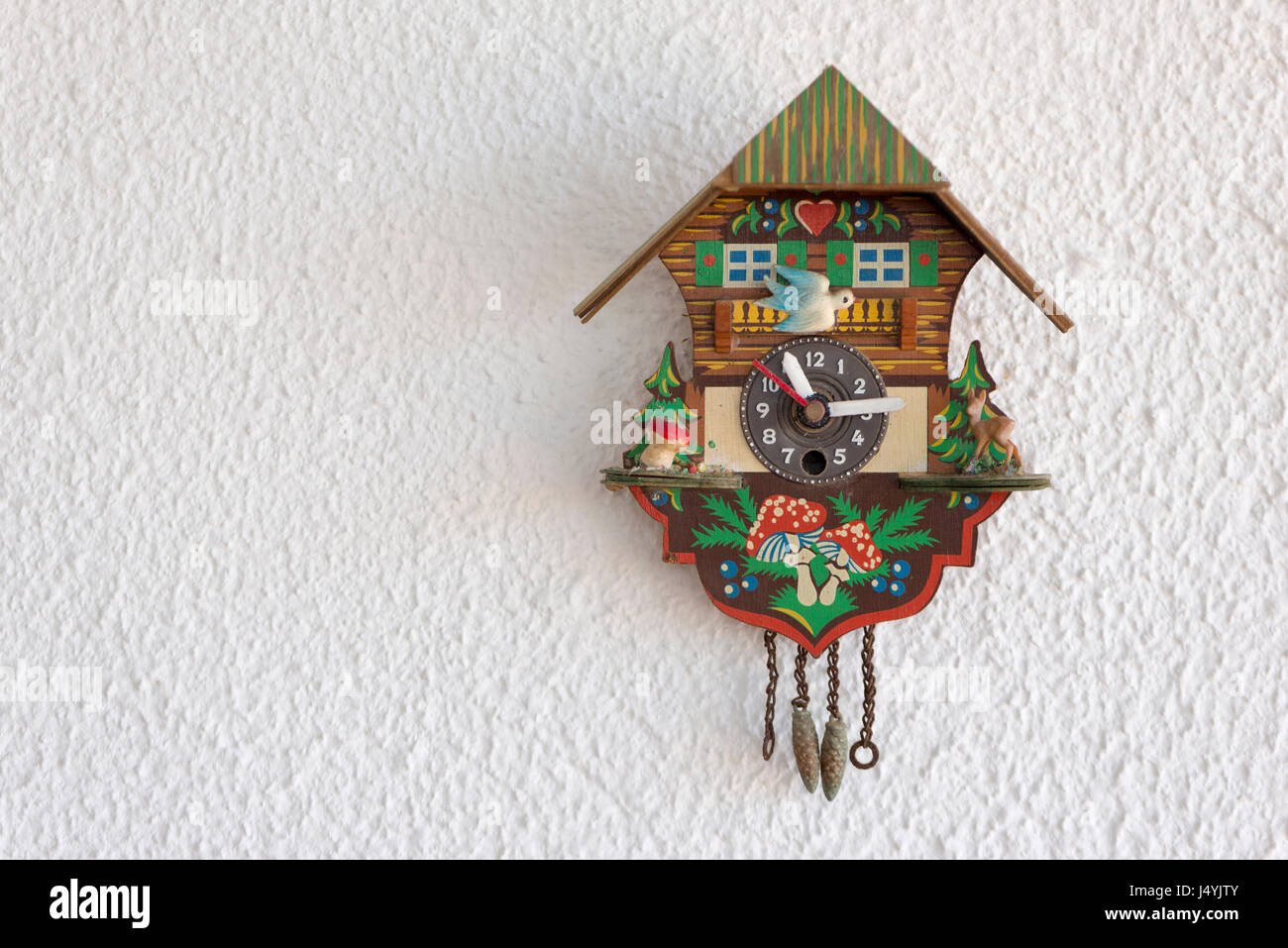 A cuckoo clock hanging on the wall Stock Photo