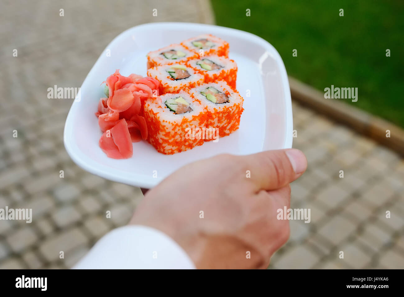 waiter carries a platter of California rolls Stock Photo Alamy