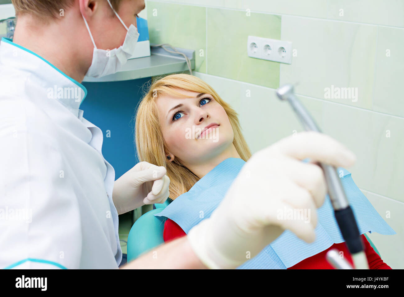 Closeup portrait smiling happy patient in dentist office, doctor
