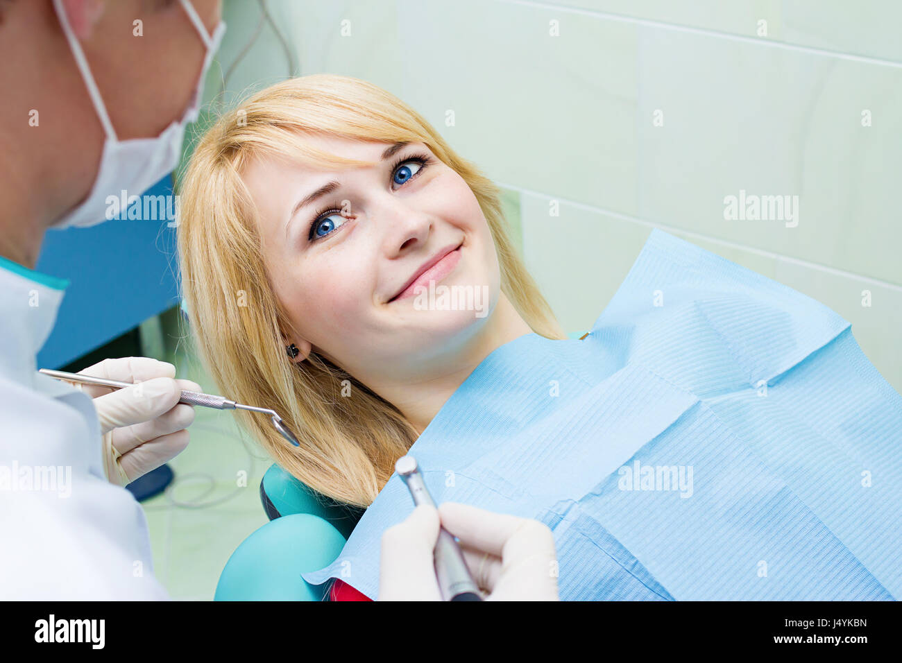 Closeup portrait smiling happy patient in dentist office, doctor