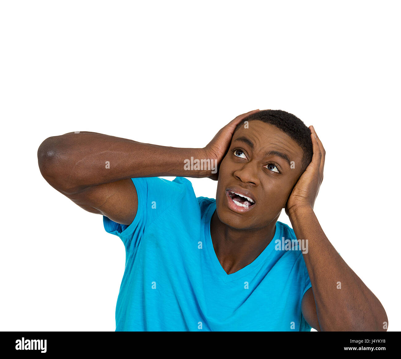 Closeup portrait young angry mad unhappy stressed man covering his ears