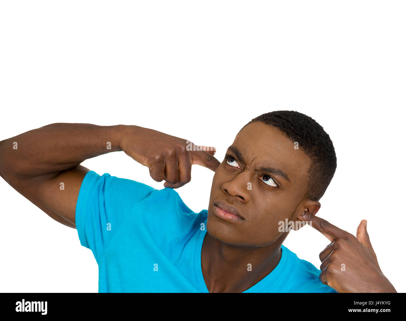 Closeup portrait young angry mad unhappy stressed man covering his ears