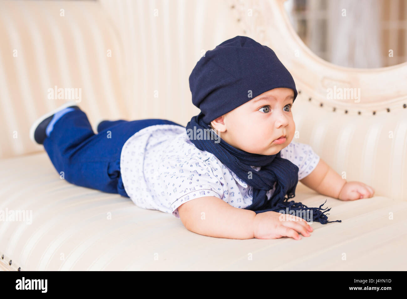 Portrait of cute baby boy wearing blue hat Stock Photo - Alamy