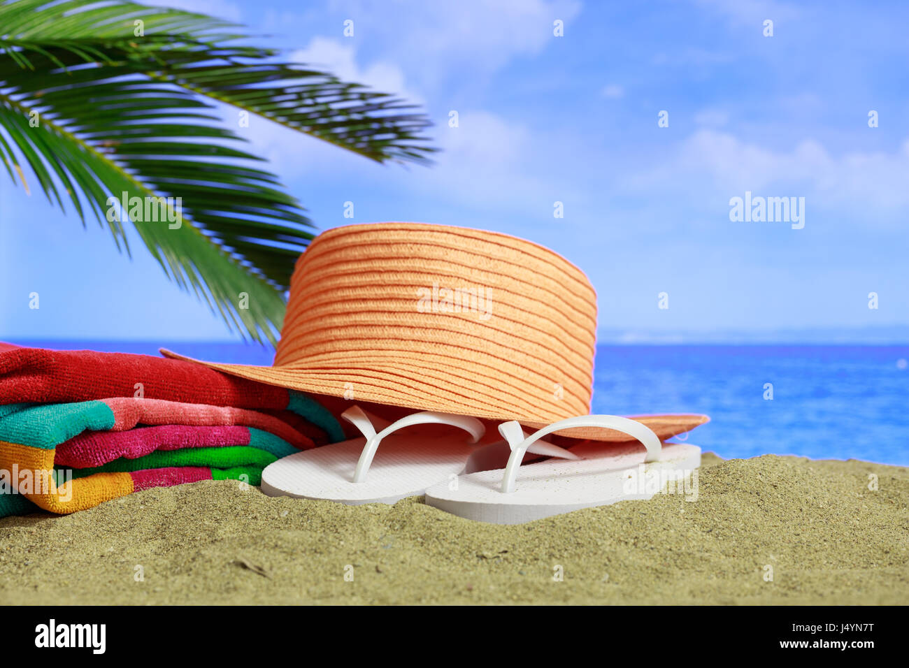 Summer vacations concept - Flip flops and hat on a sandy beach Stock ...