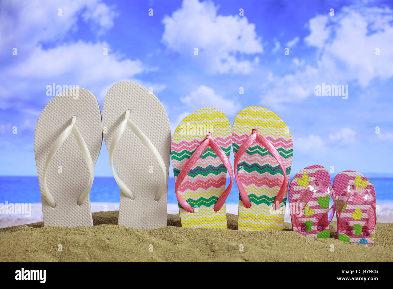 Summer vacations concept - Family flip-flops on a sandy beach Stock ...