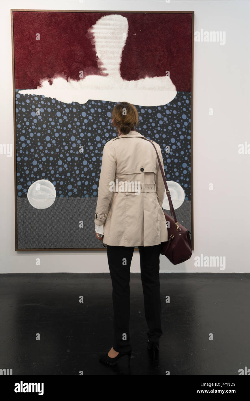 A woman is looking at a picture of Sigmar Polke. It has no title and was made in 2004. Stock Photo