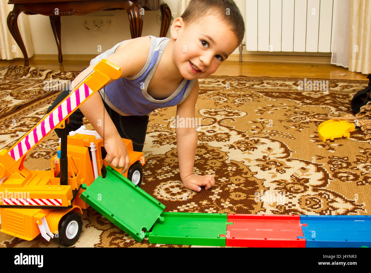 little boy plays with toy car at home Stock Photo - Alamy