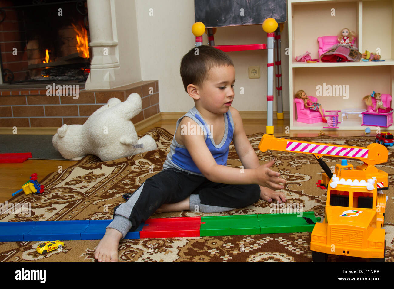 little boy plays with toy car at home Stock Photo - Alamy