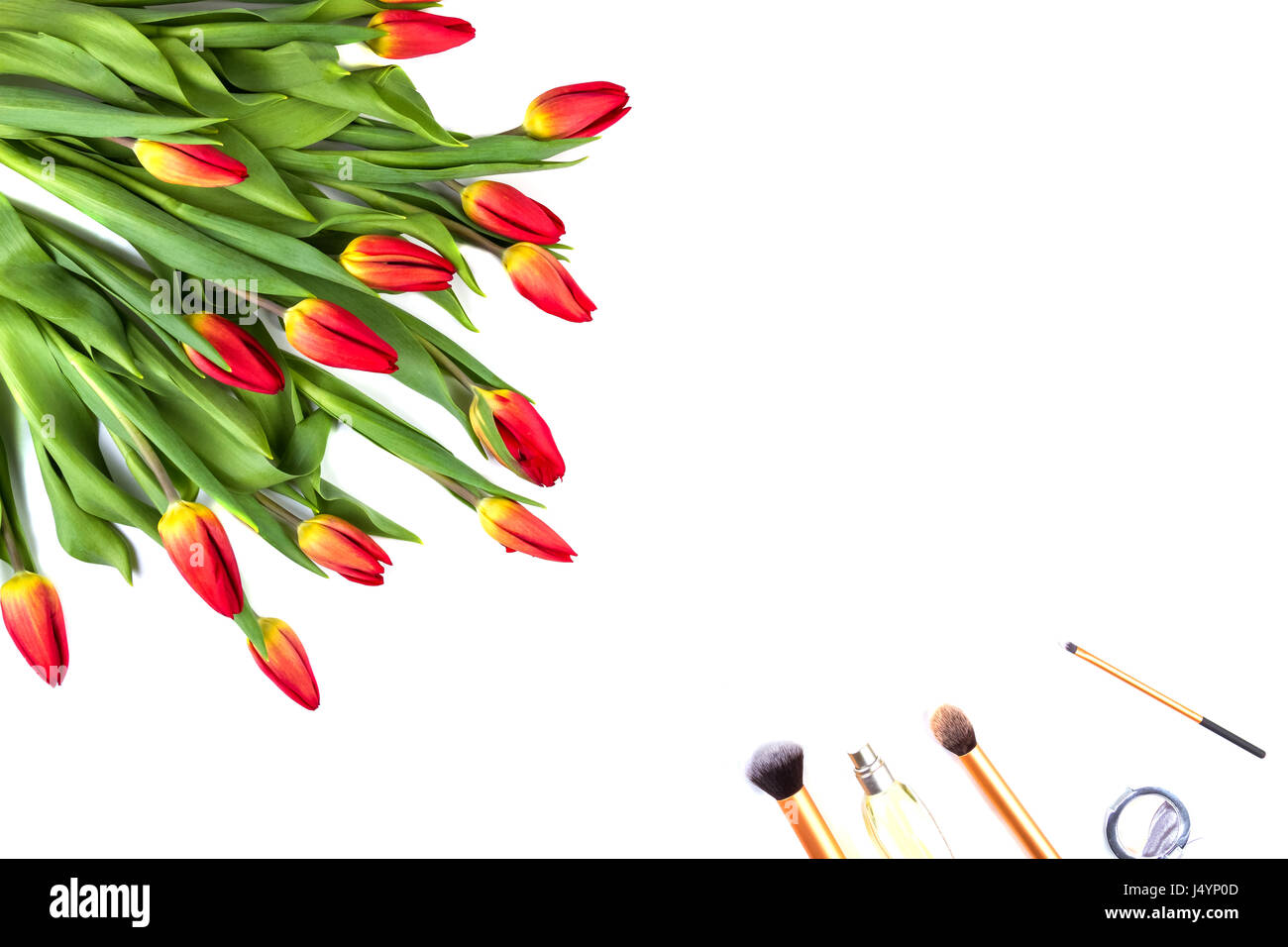 Creative background with make up brushe and flowers on white background Stock Photo