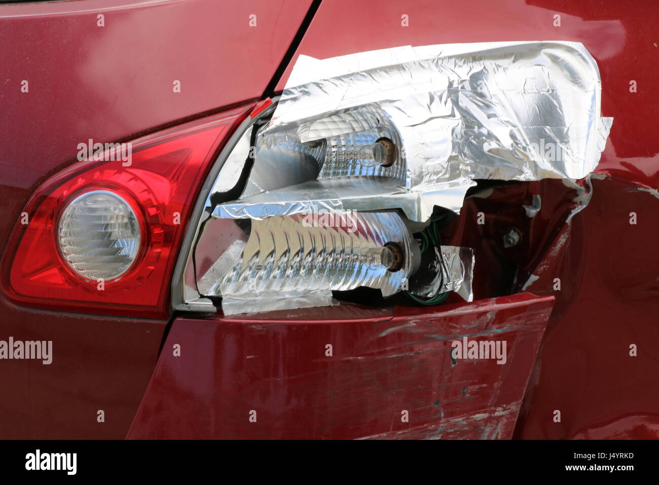 Do it yourself repair job with pipe tape to a rear tail light and bumper after a car accident. Stock Photo